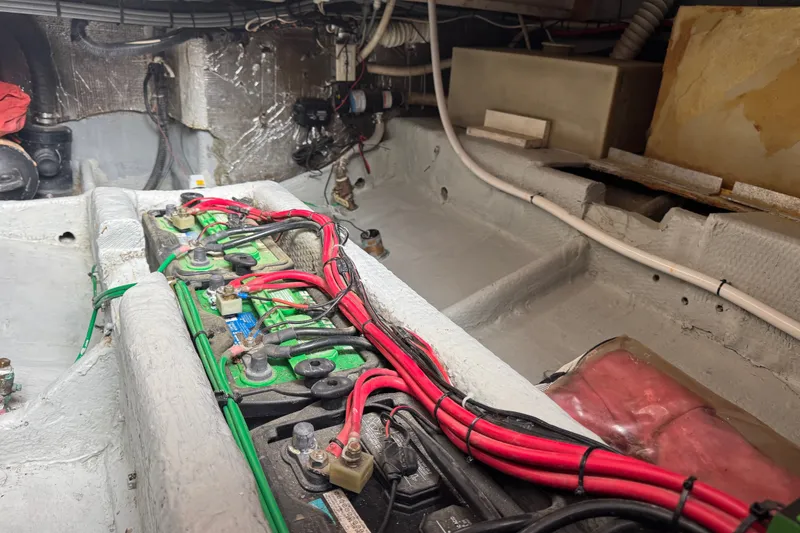 Slide: The Image of Engine compartment of a 1994 Luhrs 32 Convertible with visible wiring and components. - 68