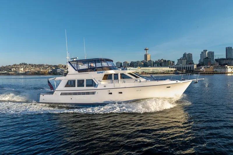 Slide: The Image of 1991 Tollycraft 57 Pilothouse Motor Yacht cruising near city skyline. - 2