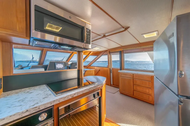 Slide: The Image of Interior of 1991 Tollycraft 57 Pilothouse Motor Yacht with modern kitchen and ocean view. - 22