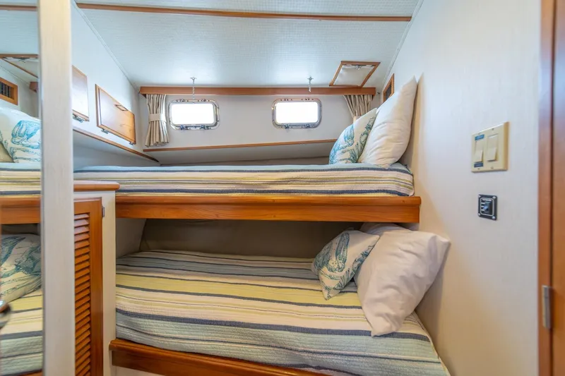 Slide: The Image of Bunk beds in 1991 Tollycraft 57 Pilothouse Motor Yacht cabin, featuring striped bedding. - 40