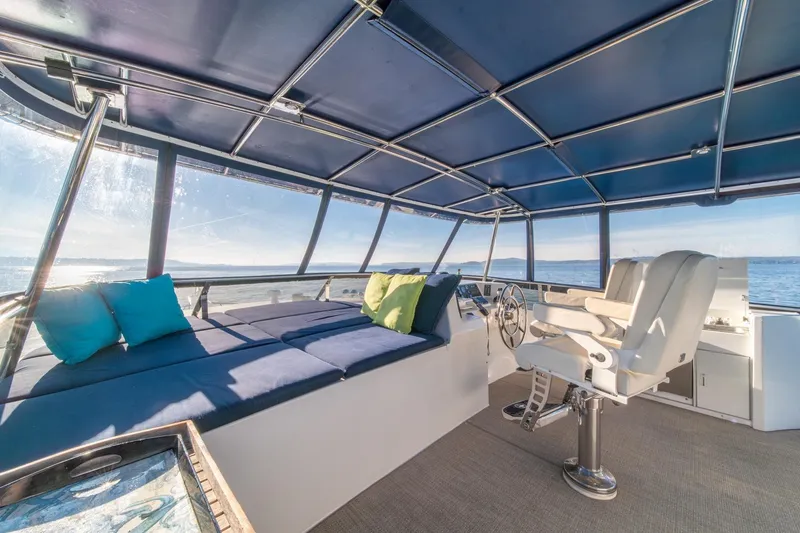 Slide: The Image of Luxurious 1991 Tollycraft 57 Pilothouse Motor Yacht interior with seating and ocean view. - 58