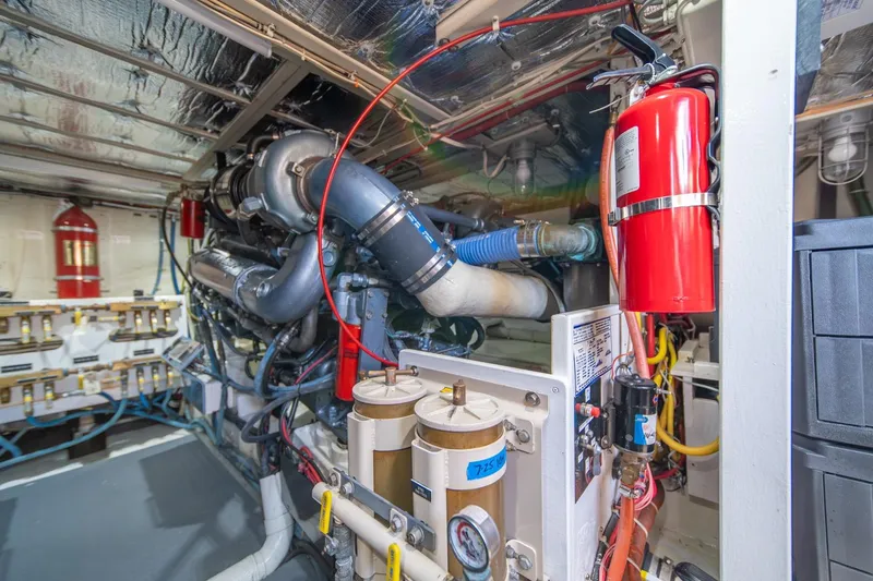 Slide: The Image of Engine room of 1991 Tollycraft 57 Pilothouse Motor Yacht with fire extinguisher and machinery. - 63
