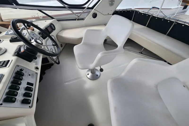 Slide: The Image of Interior view of 1996 Sea Ray 370 Sedan Bridge helm with steering wheel and seating. - 10