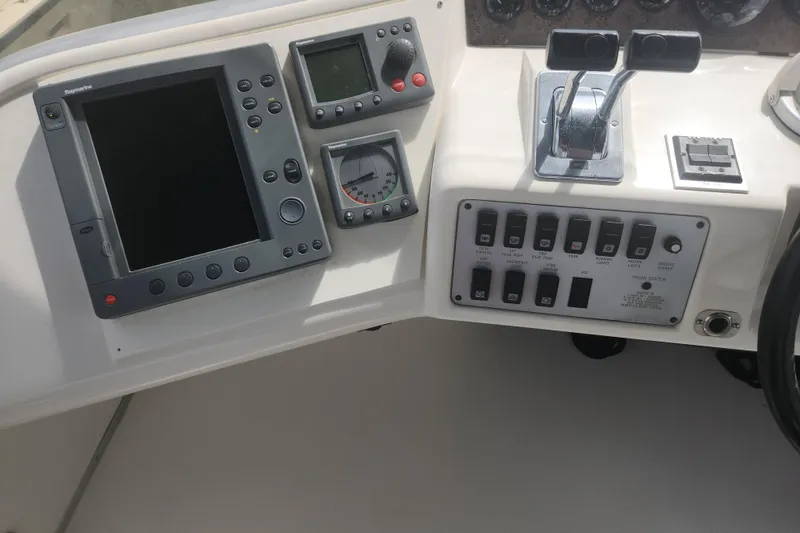 Slide: The Image of 1996 Sea Ray 370 Sedan Bridge dashboard with navigation controls and switches. - 12