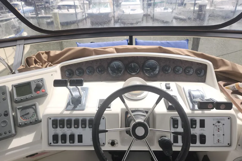 Slide: The Image of Cockpit view of a 1996 Sea Ray 370 Sedan Bridge with steering wheel and control panel. - 13