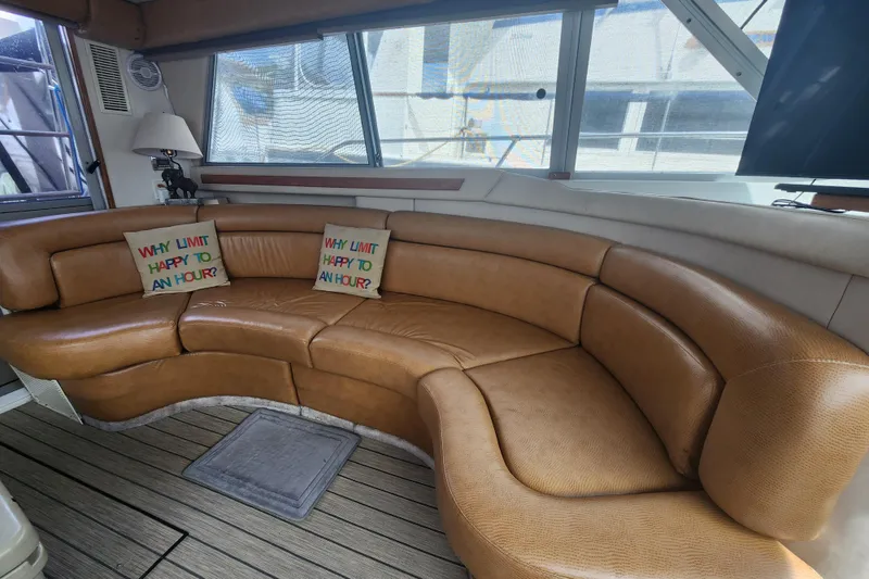 Slide: The Image of Luxurious interior of 1996 Sea Ray 370 Sedan Bridge with curved leather seating. - 15