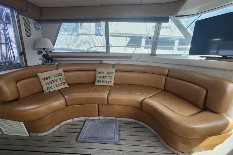 Slide: The Image of Luxurious interior of 1996 Sea Ray 370 Sedan Bridge with curved leather seating. - 16