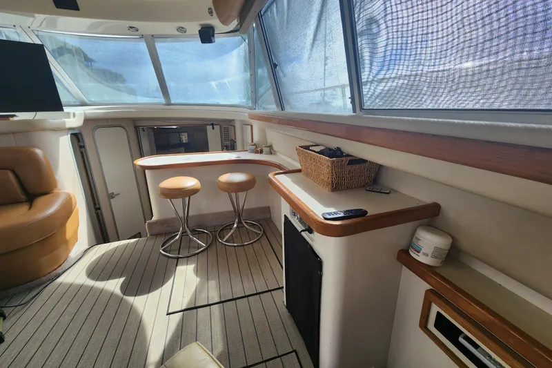 Slide: The Image of Interior of 1996 Sea Ray 370 Sedan Bridge with seating and bar area. - 19