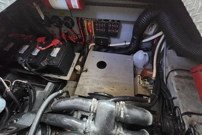 Slide: The Image of Engine compartment of a 1996 Sea Ray 370 Sedan Bridge with batteries and wiring. - 22