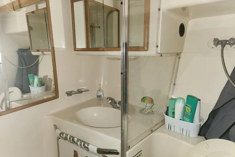 Slide: The Image of Bathroom interior of 1996 Sea Ray 370 Sedan Bridge yacht, featuring sink and toiletries. - 29