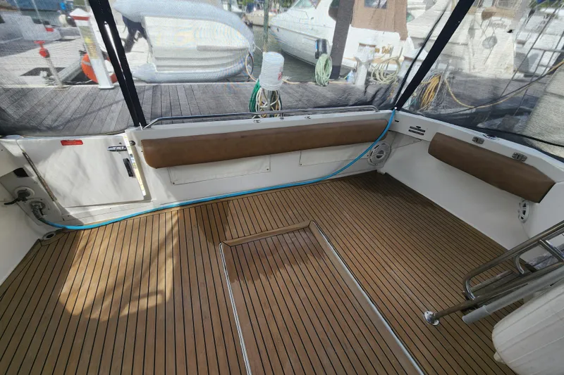 Slide: The Image of Spacious deck of 1996 Sea Ray 370 Sedan Bridge with wood flooring and seating. - 3