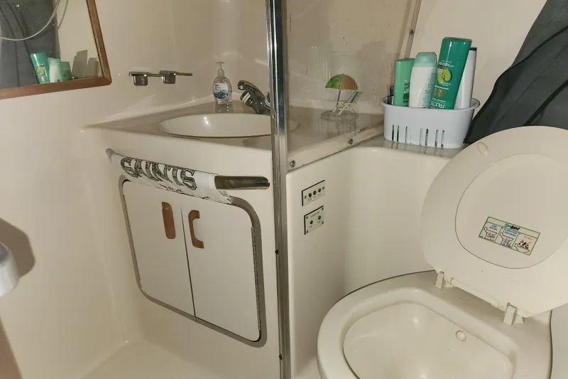 Slide: The Image of Bathroom interior of 1996 Sea Ray 370 Sedan Bridge yacht with sink and toilet. - 30