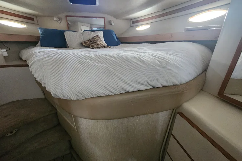 Slide: The Image of Cozy bedroom interior of 1996 Sea Ray 370 Sedan Bridge yacht with plush bedding. - 31