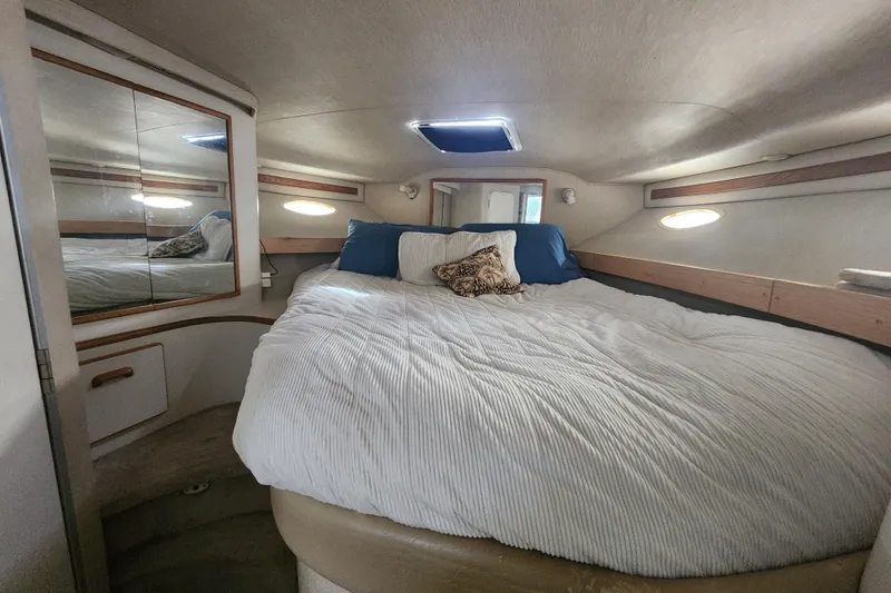 Slide: The Image of Cozy bedroom interior of 1996 Sea Ray 370 Sedan Bridge yacht with plush bedding. - 32