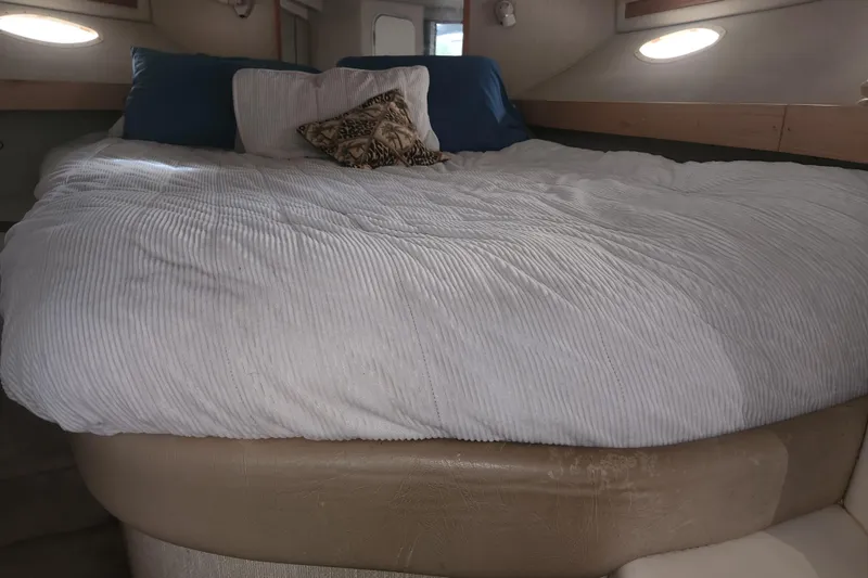 Slide: The Image of Interior cabin of 1996 Sea Ray 370 Sedan Bridge with cozy bed and pillows. - 33
