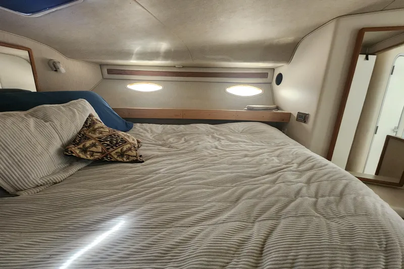 Slide: The Image of Cozy cabin interior of 1996 Sea Ray 370 Sedan Bridge with comfortable bedding. - 34