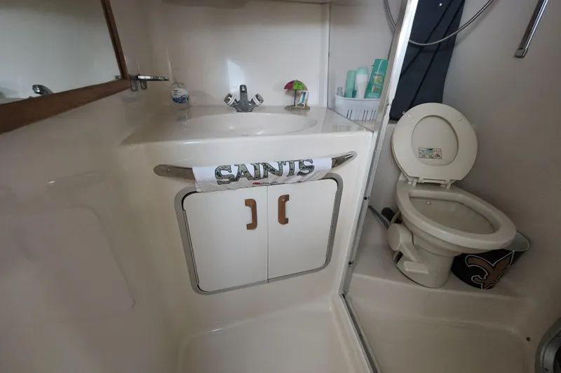 Slide: The Image of Bathroom interior of 1996 Sea Ray 370 Sedan Bridge with sink and toilet. - 36