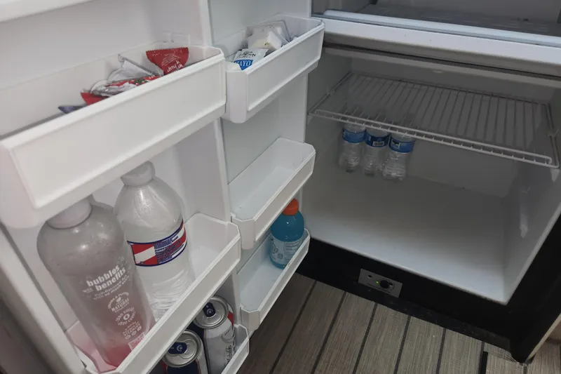 Slide: The Image of Refrigerator stocked with drinks and condiments on a 1996 Sea Ray 370 Sedan Bridge yacht. - 38