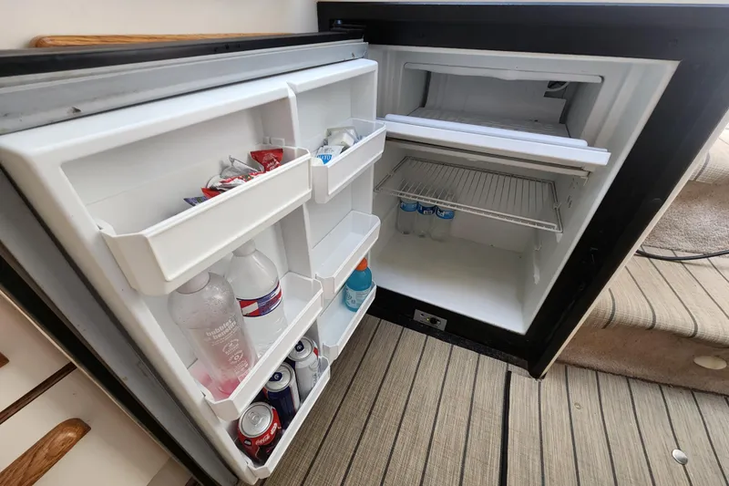 Slide: The Image of Open refrigerator on 1996 Sea Ray 370 Sedan Bridge yacht, stocked with beverages. - 39