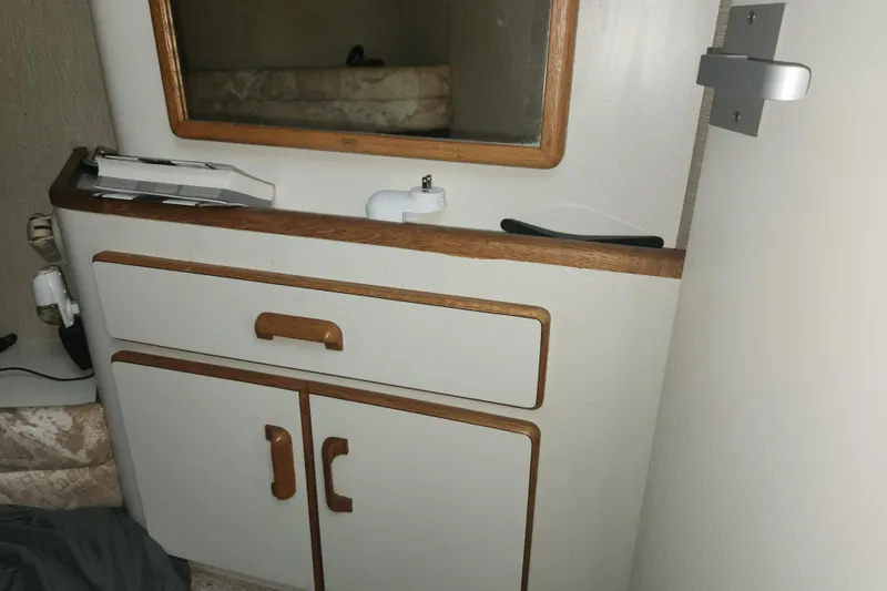 Slide: The Image of Interior of 1996 Sea Ray 370 Sedan Bridge with wooden cabinet and mirror. - 40