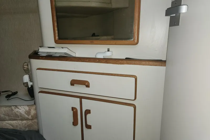 Slide: The Image of Interior of 1996 Sea Ray 370 Sedan Bridge with wooden cabinetry and mirror. - 41