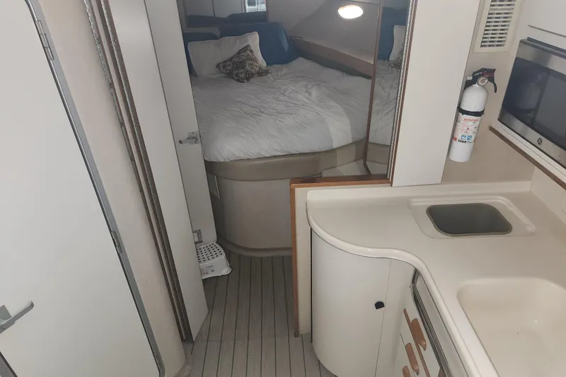 Slide: The Image of Interior of 1996 Sea Ray 370 Sedan Bridge with bed and kitchenette. - 44