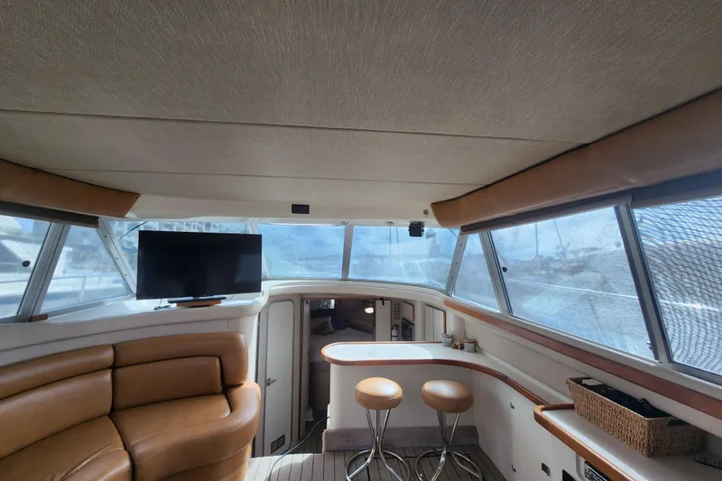 Slide: The Image of Interior of 1996 Sea Ray 370 Sedan Bridge with leather seating and panoramic windows. - 47