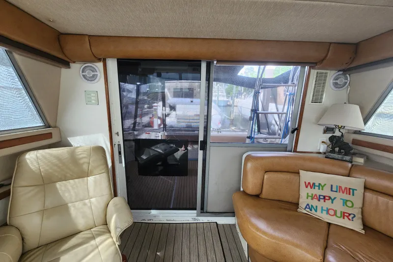 Slide: The Image of Interior of 1996 Sea Ray 370 Sedan Bridge with leather seating and decorative pillow. - 48