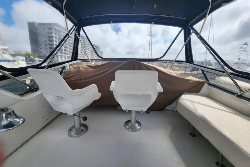 Slide: The Image of Interior view of 1996 Sea Ray 370 Sedan Bridge with two white captain chairs. - 5