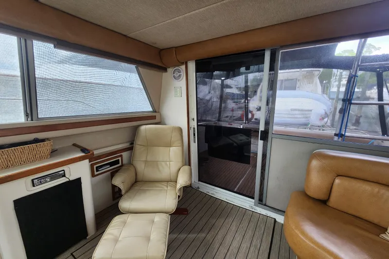 Slide: The Image of Interior of 1996 Sea Ray 370 Sedan Bridge with leather seating and sliding glass door. - 50