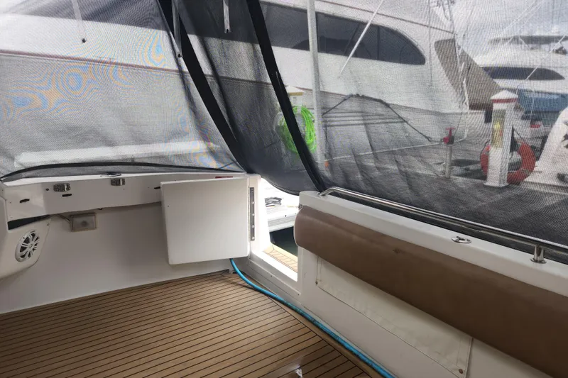 Slide: The Image of 1996 Sea Ray 370 Sedan Bridge interior with wood flooring and mesh covering. - 54