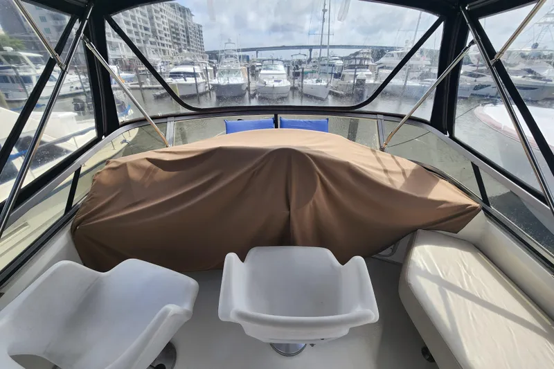 Slide: The Image of Interior view of a 1996 Sea Ray 370 Sedan Bridge yacht at a marina. - 6