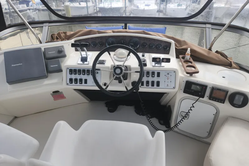 Slide: The Image of Cockpit of 1996 Sea Ray 370 Sedan Bridge with steering wheel and navigation controls. - 8
