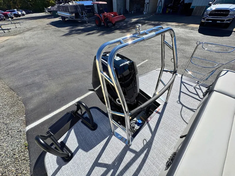 Slide: The Image of A 2027 Harris Cruiser 230 with a shiny outboard motor and sturdy stainless steel railings. - 7