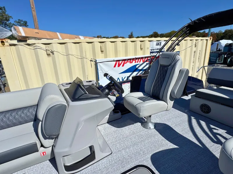 Slide: The Image of The image shows the cockpit of a 2027 Harris Cruiser 230 with gray seats and a helm console. - 16