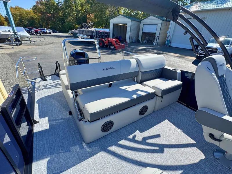 Slide: The Image of 2027 Harris Cruiser 230 with gray upholstery and modern design, parked in an outdoor area. - 11