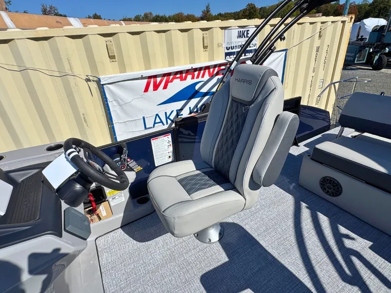 Slide: The Image of The 2027 Harris Cruiser 230 features a sleek captain's chair and modern helm station. - 17