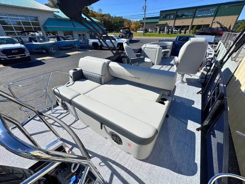 Slide: The Image of The image shows the deck of a 2027 Harris Cruiser 230 with comfortable seating and speakers. - 9