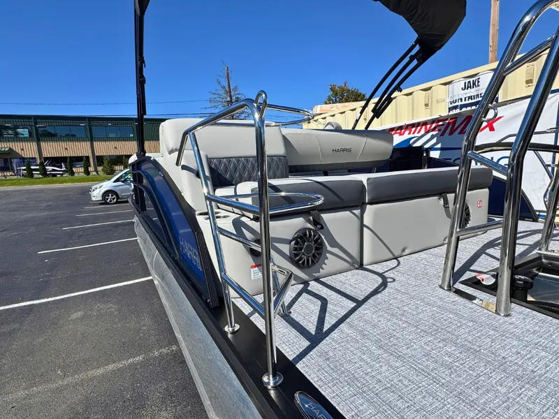 Slide: The Image of 2027 Harris Cruiser 230 with sleek seating and modern details in an outdoor setting. - 8