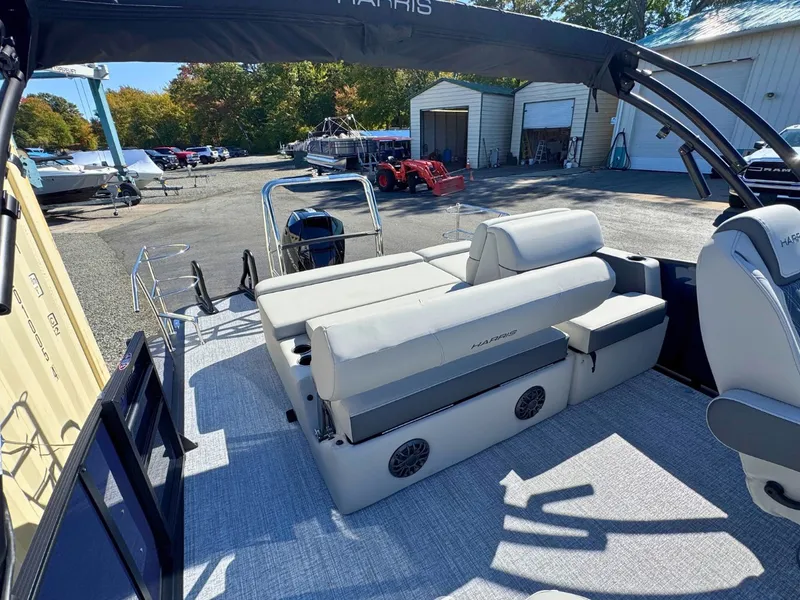 Slide: The Image of The image shows the deck of a 2027 Harris Cruiser 230 with comfortable seating and speakers. - 12