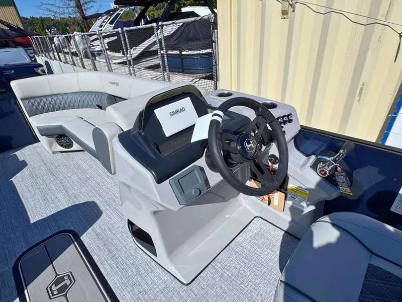 Slide: The Image of The image shows the cockpit of a 2027 Harris Cruiser 230 with a modern helm station. - 18
