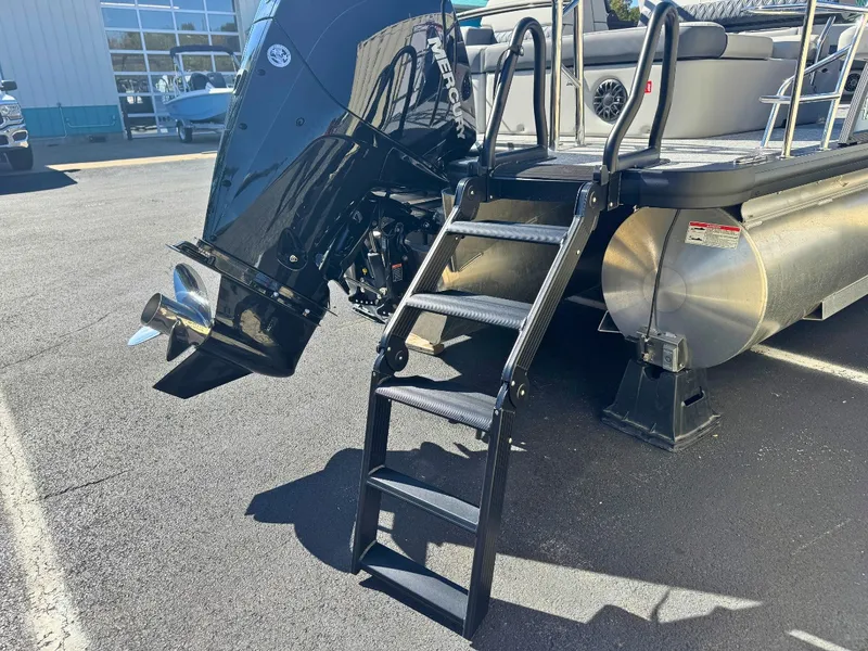 Slide: The Image of A 2027 Harris Cruiser 230 with a black motor ladder and silver pontoons. - 6