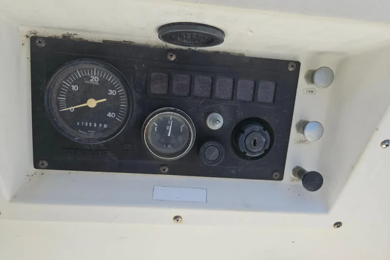 Slide: The Image of Control panel of a 1986 C & C 29 SL boat with RPM gauge and switches. - 12