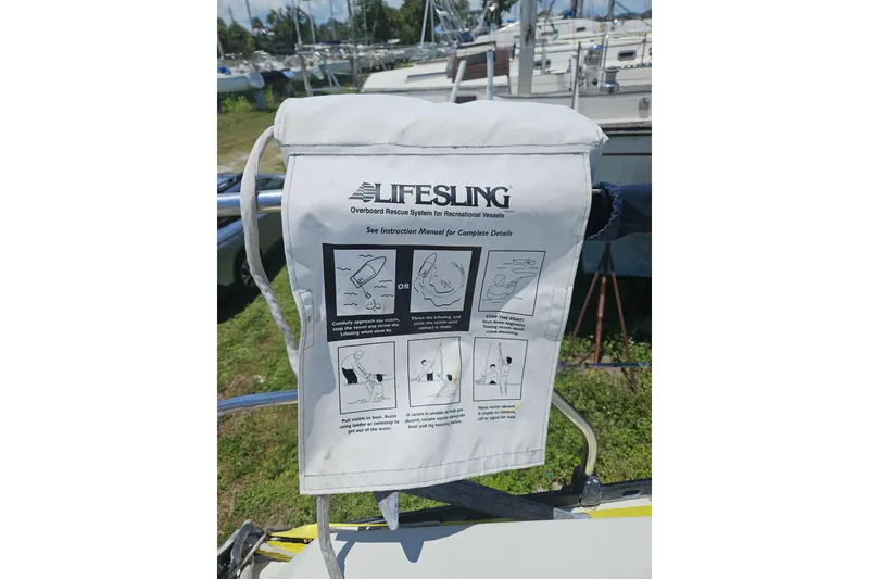 Slide: The Image of Lifesling overboard rescue system on a 1986 C & C 29 SL sailboat, docked with other vessels. - 14