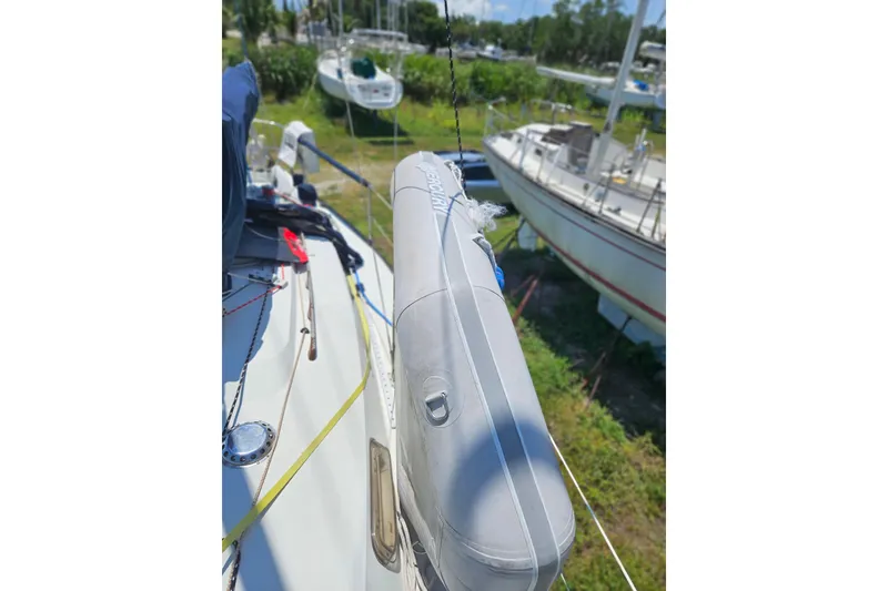 Slide: The Image of 1986 C & C 29 SL sailboat deck with lifebuoy, docked in marina. - 16
