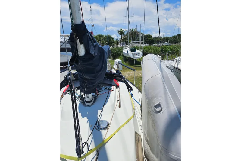 Slide: The Image of 1986 C & C 29 SL sailboat deck with rigging and inflatable dinghy. - 18