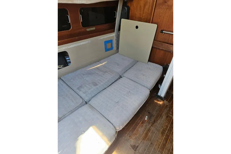 Slide: The Image of Interior of 1986 C & C 29 SL sailboat with cushioned seating and wooden paneling. - 22
