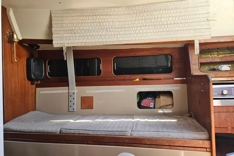 Slide: The Image of Interior of a 1986 C & C 29 SL sailboat with wooden accents and seating area. - 23