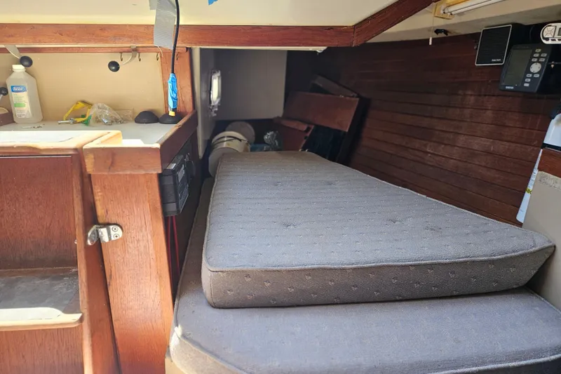 Slide: The Image of Interior of 1986 C & C 29 SL sailboat with wooden cabinetry and cushions. - 24