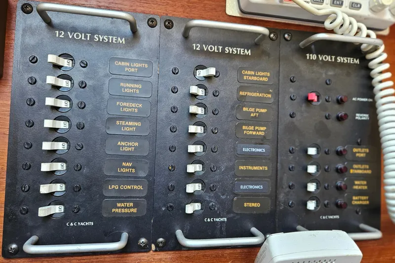 Slide: The Image of Electrical panel of a 1986 C & C 29 SL yacht, featuring 12V and 110V systems. - 29